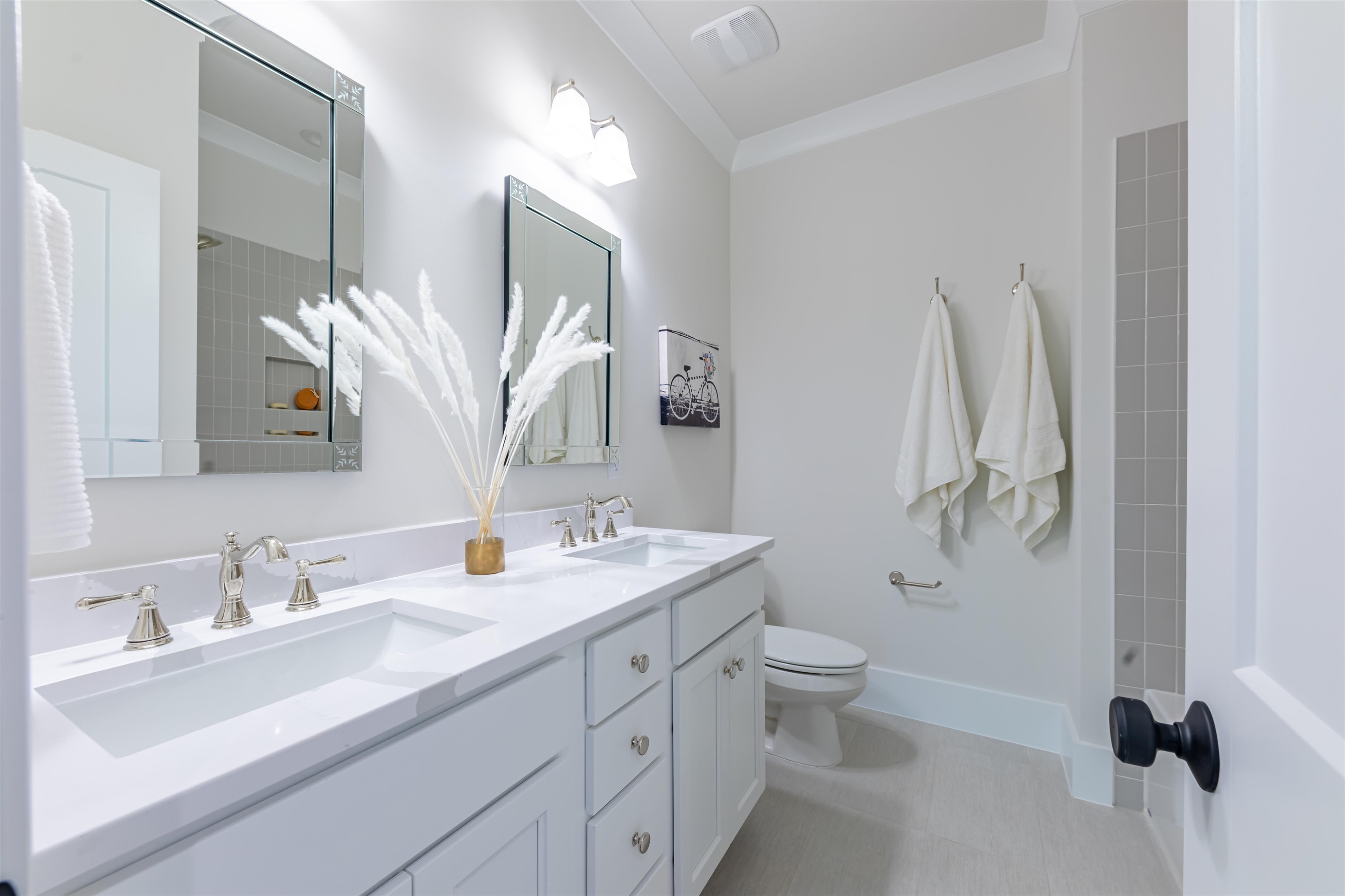 1220 Dixie Trail Raleigh, NC 27607 - Photo 27 of 40 a bathroom with a double vanity sink toilet and mirror