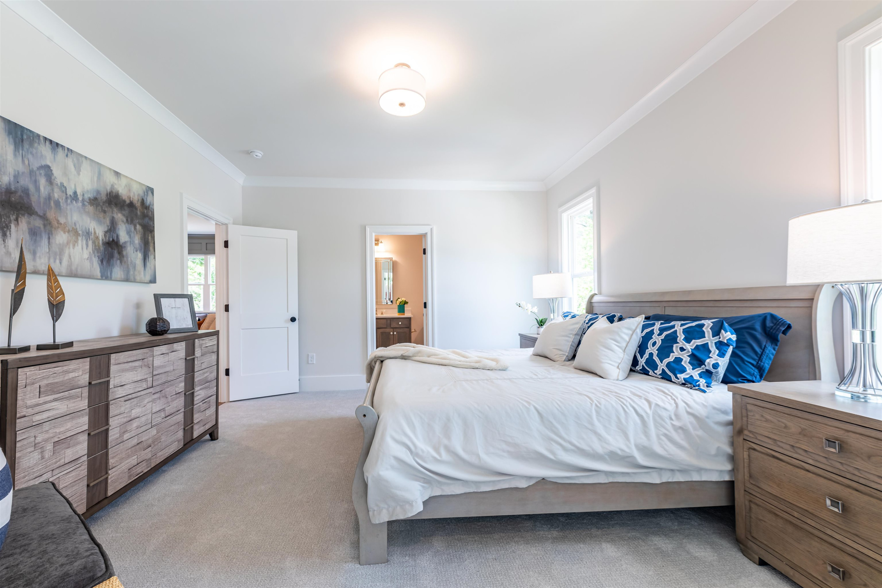 1220 Dixie Trail Raleigh, NC 27607 - Photo 33 of 40 a bedroom with a bed and dresser with mirror