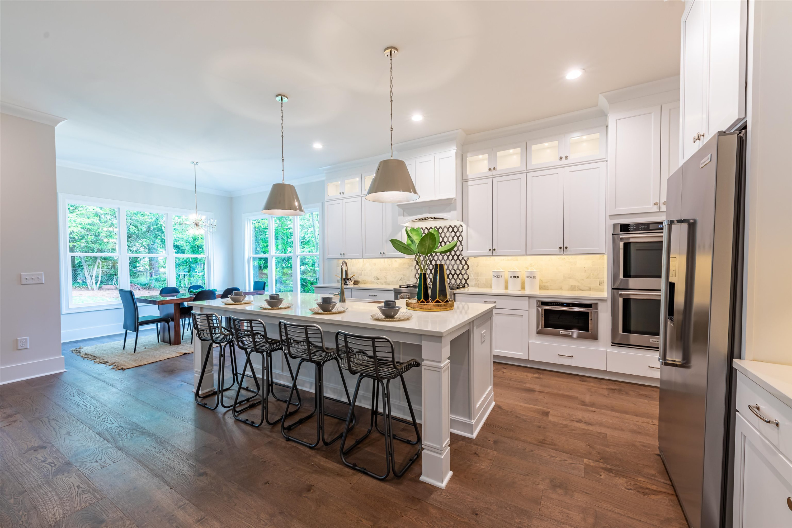 1220 Dixie Trail Raleigh, NC 27607 - Photo 10 of 40 a kitchen with stainless steel appliances kitchen island granite countertop a table chairs and a refrigerator