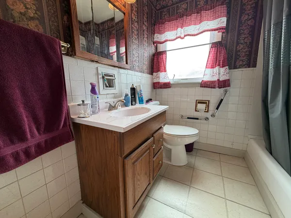 a bathroom with a sink a toilet and tub