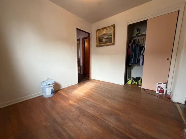 a view of an empty room and wooden floor