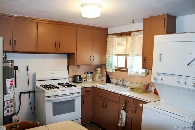 a kitchen with a sink cabinets and appliances