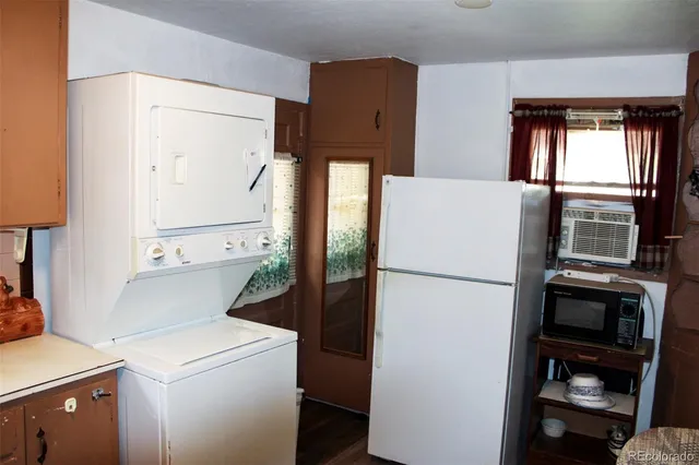 a white refrigerator freezer and a stove sitting inside of a kitchen