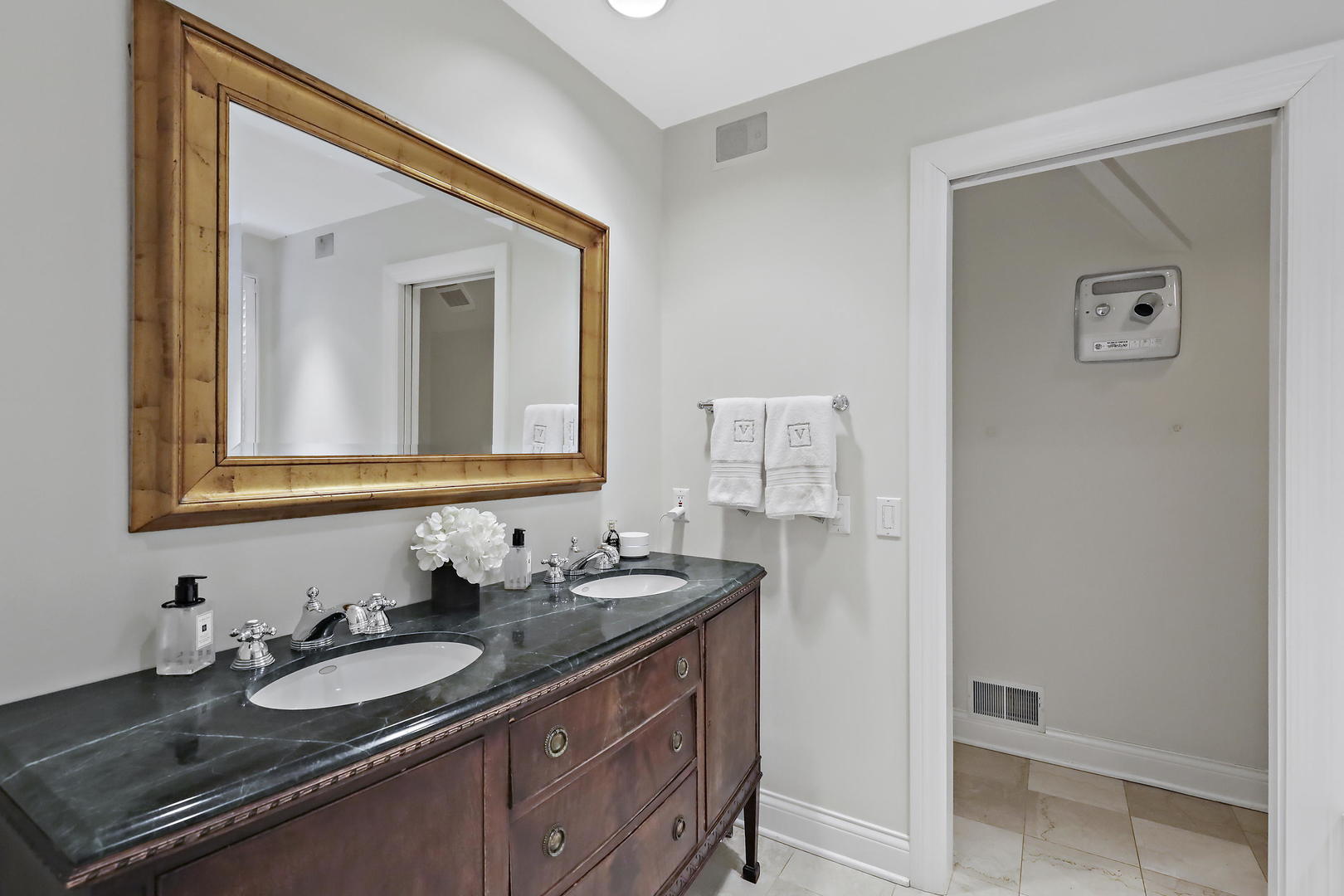 138 East Sheridan Road Lake Bluff, IL 60044 - Photo 24 of 39 a bathroom with a granite countertop sink and a mirror