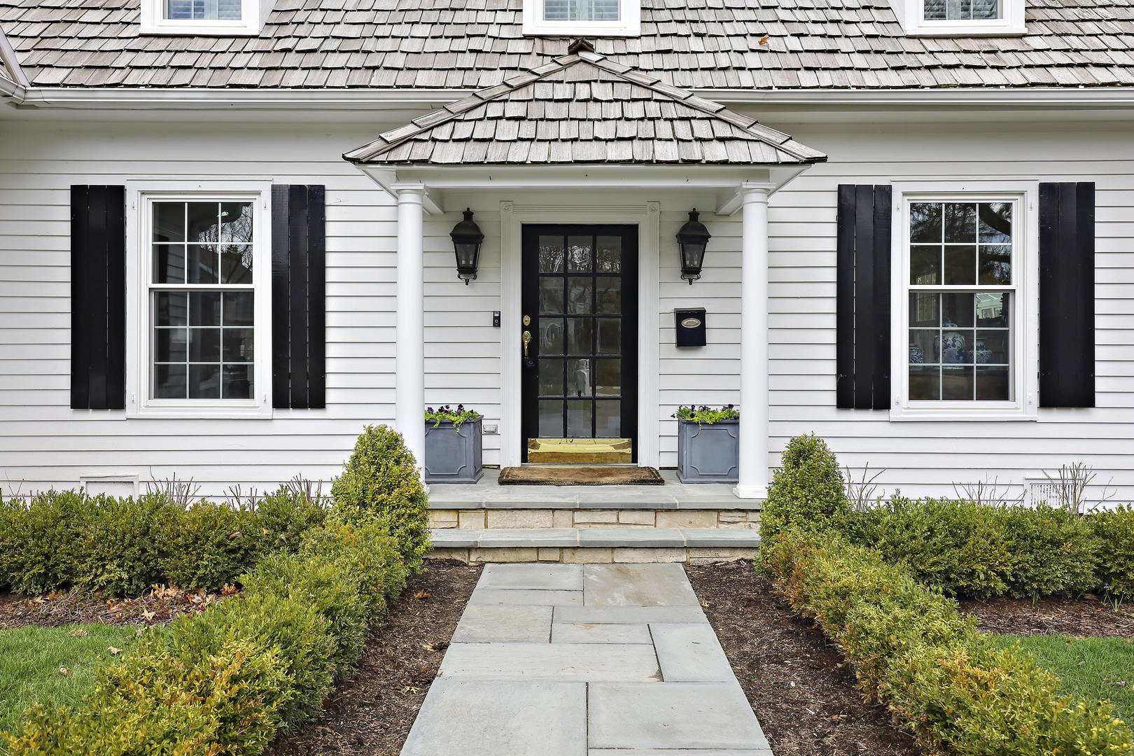 138 East Sheridan Road Lake Bluff, IL 60044 - Photo 37 of 39 a view of a brick house with potted plants