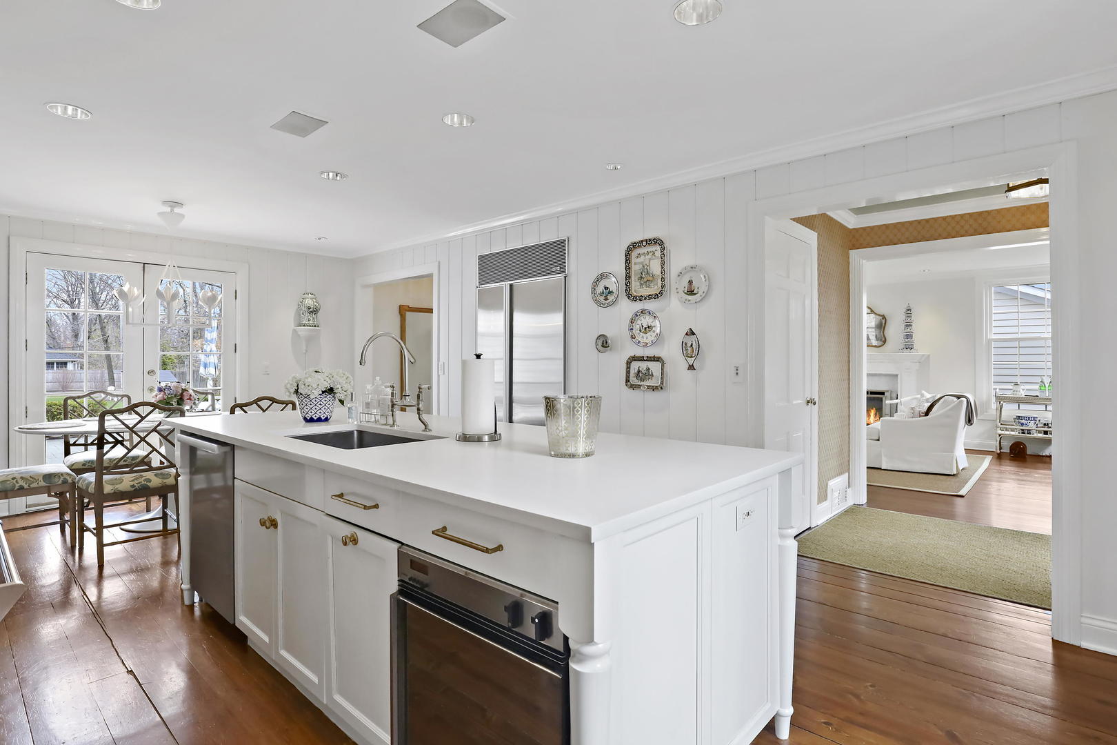 138 East Sheridan Road Lake Bluff, IL 60044 - Photo 7 of 39 a view of a kitchen counter space a sink wooden floor and living room view