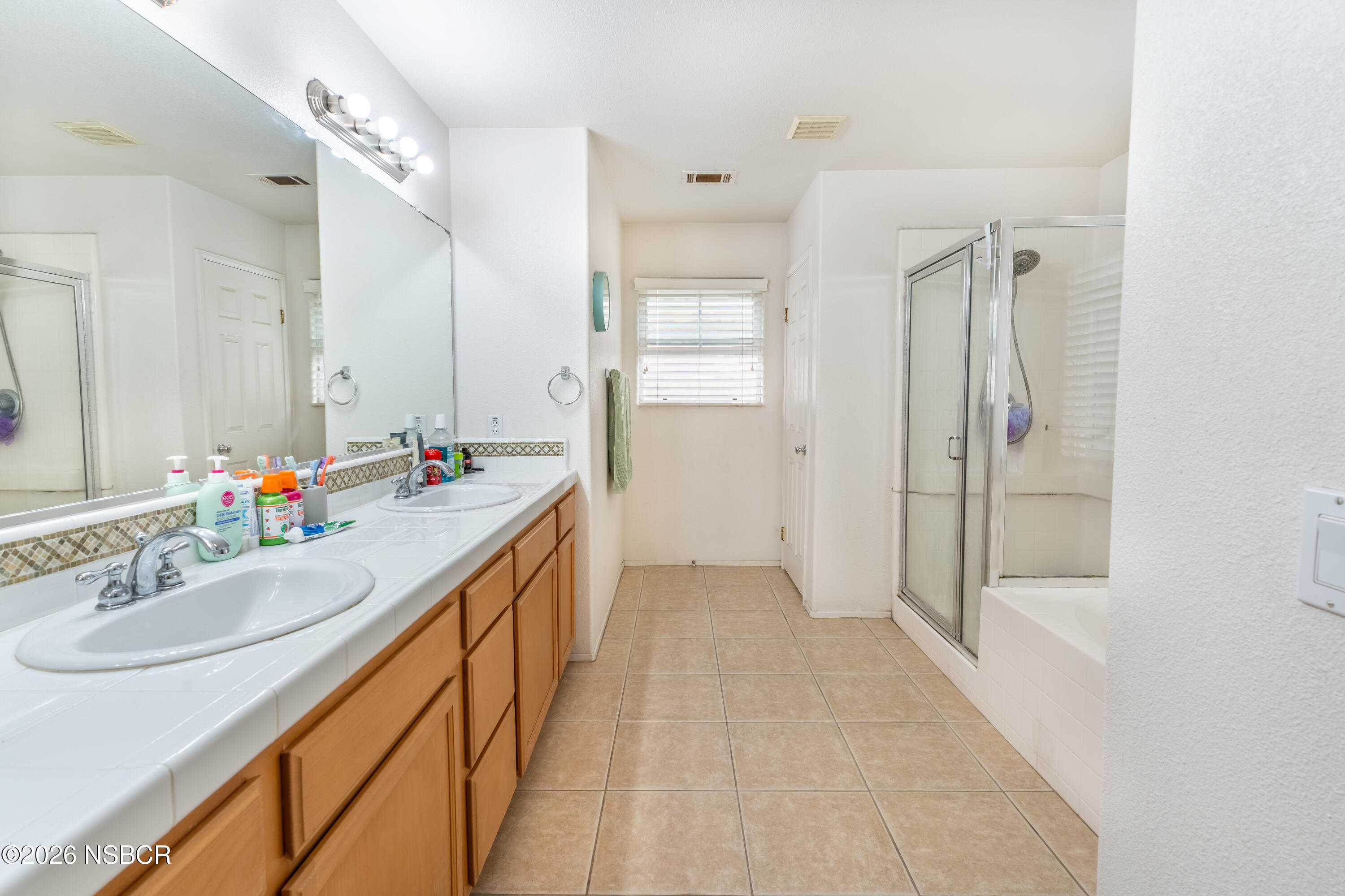 240 Quail Circle Lompoc, CA 93436 - Photo 11 of 19 a bathroom with a sink and a mirror