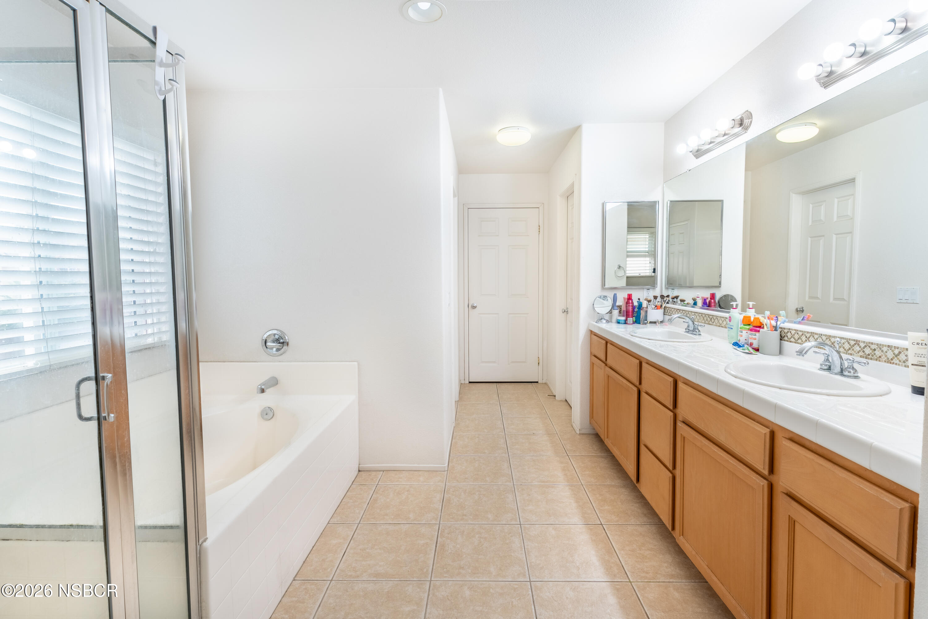 240 Quail Circle Lompoc, CA 93436 - Photo 12 of 19 a bathroom with a tub sink and mirror