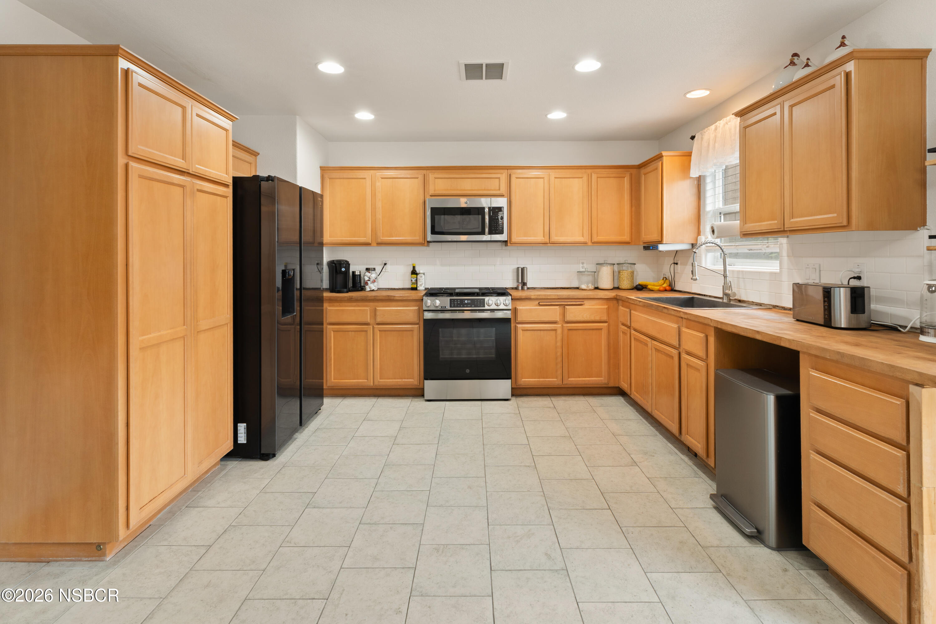 240 Quail Circle Lompoc, CA 93436 - Photo 5 of 19 a large kitchen with stainless steel appliances granite countertop a stove top oven a refrigerator and a granite counter top