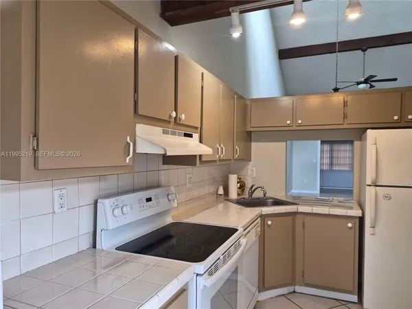 a kitchen with cabinets and window