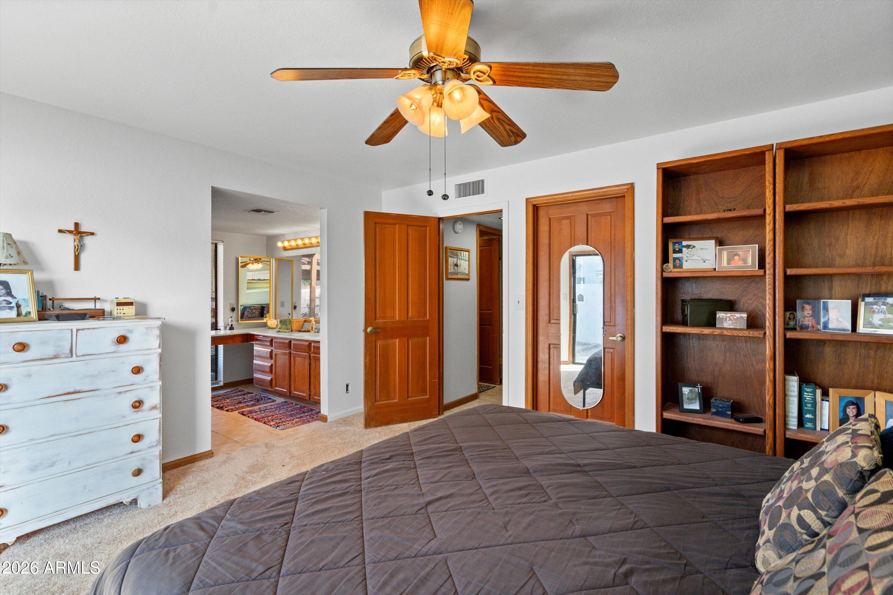1301 West Rio Salado Parkway, Unit 22 Mesa, AZ 85201 - Photo 11 of 21 a bedroom with a bed and a chandelier