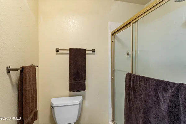 a bathroom with a toilet and a shower curtain