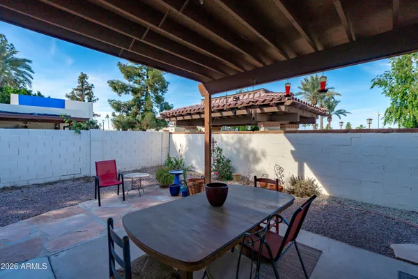 a view of patio with a table and chairs