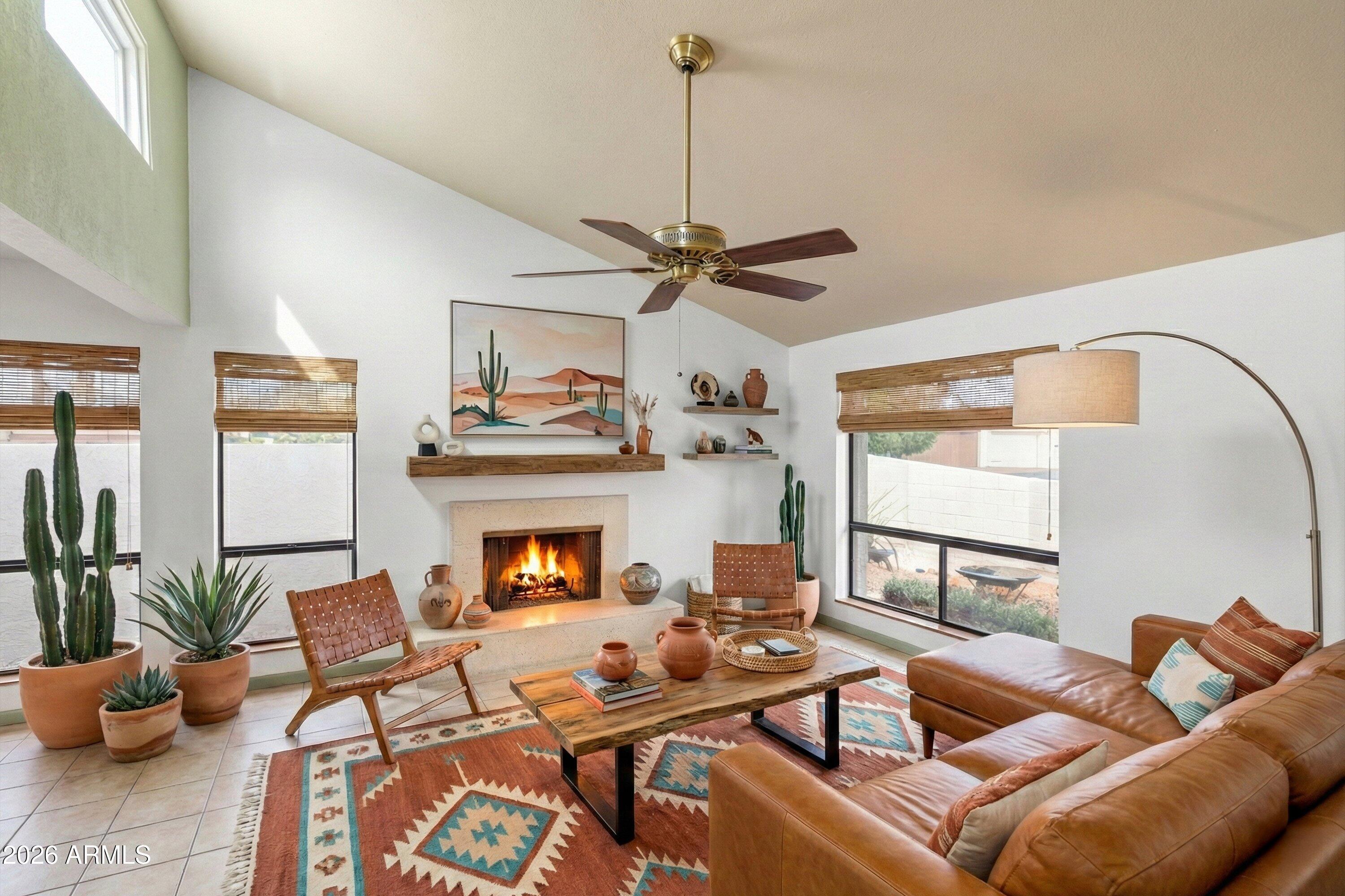 1301 West Rio Salado Parkway, Unit 22 Mesa, AZ 85201 - Photo 5 of 21 a living room with furniture a fireplace and a chandelier