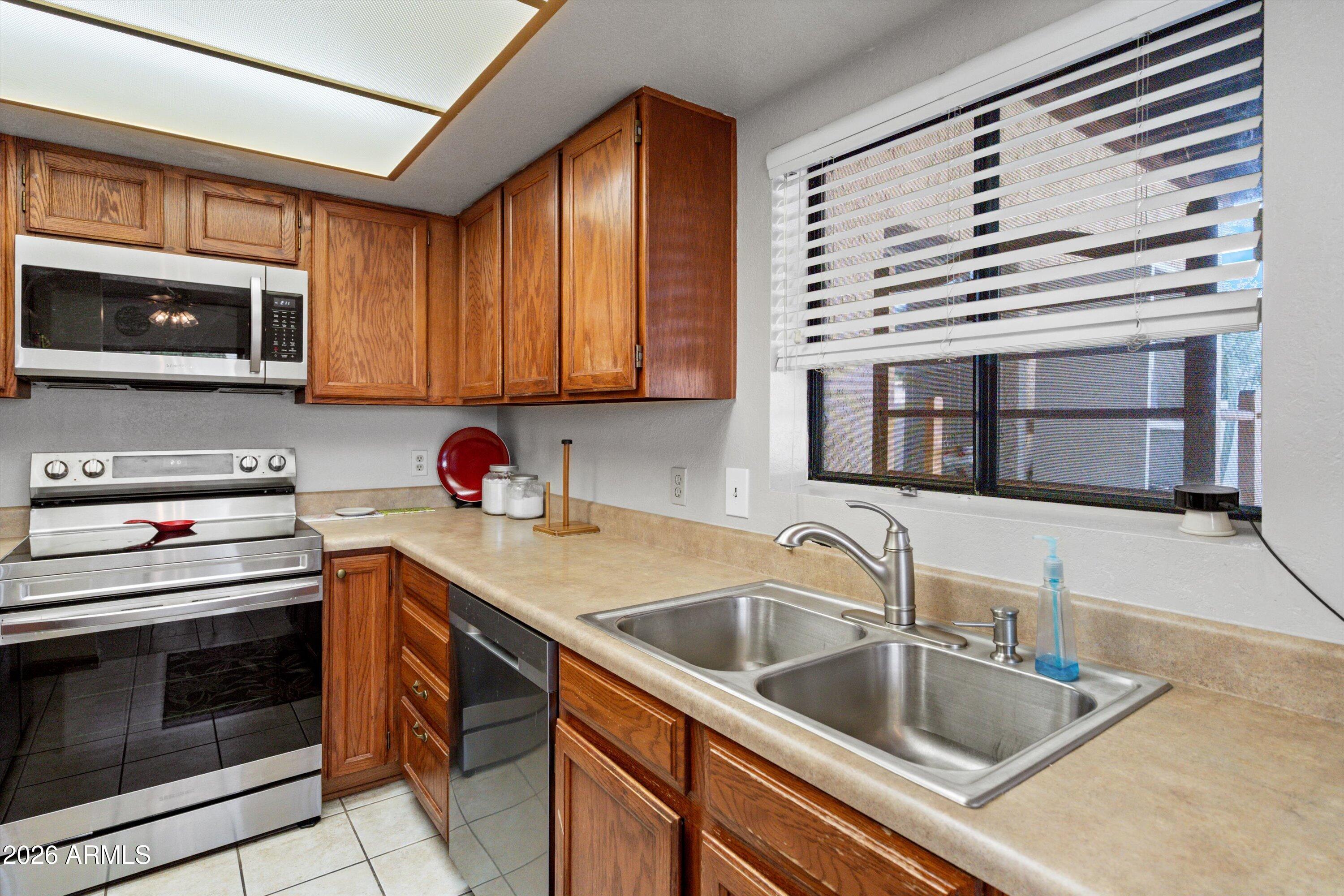 1301 West Rio Salado Parkway, Unit 22 Mesa, AZ 85201 - Photo 7 of 21 a kitchen that has a sink and a stove