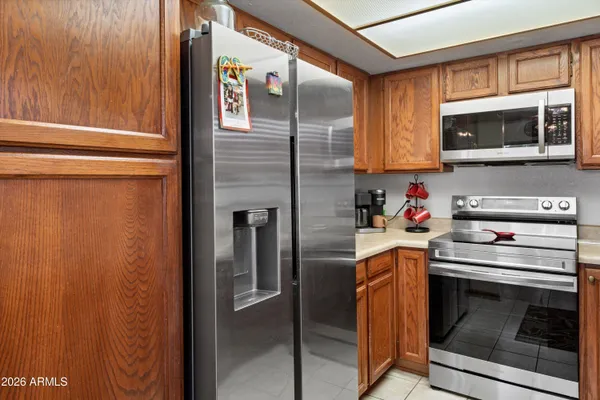 a kitchen with stainless steel appliances granite countertop a stove microwave and refrigerator
