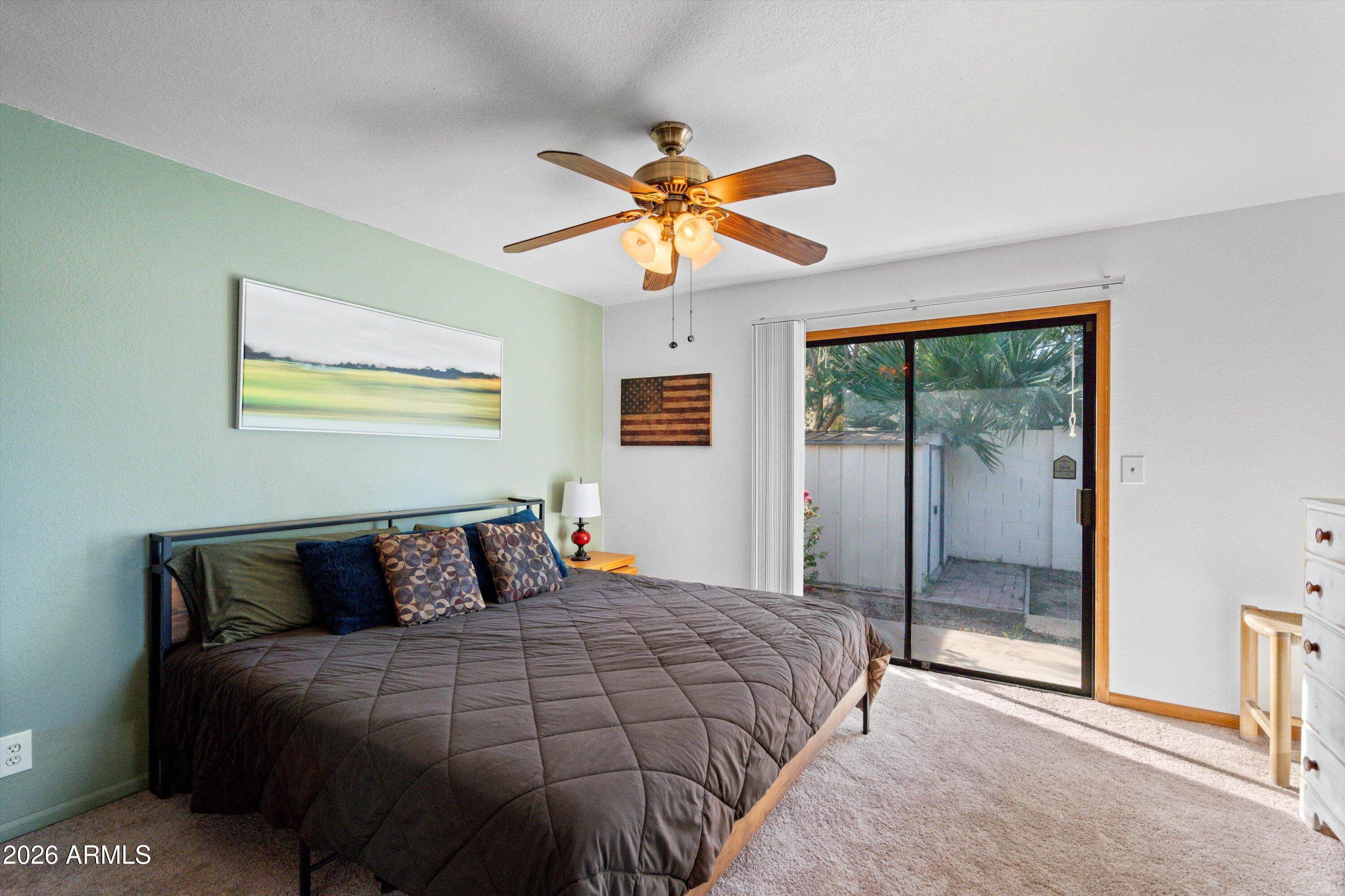 1301 West Rio Salado Parkway, Unit 22 Mesa, AZ 85201 - Photo 9 of 21 a bedroom with a bed and a chandelier