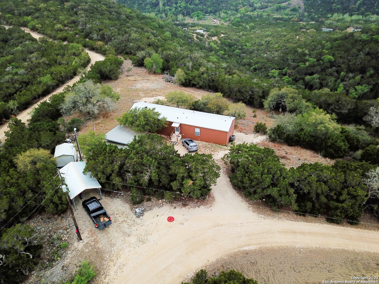an aerial view of a house with yard and parking