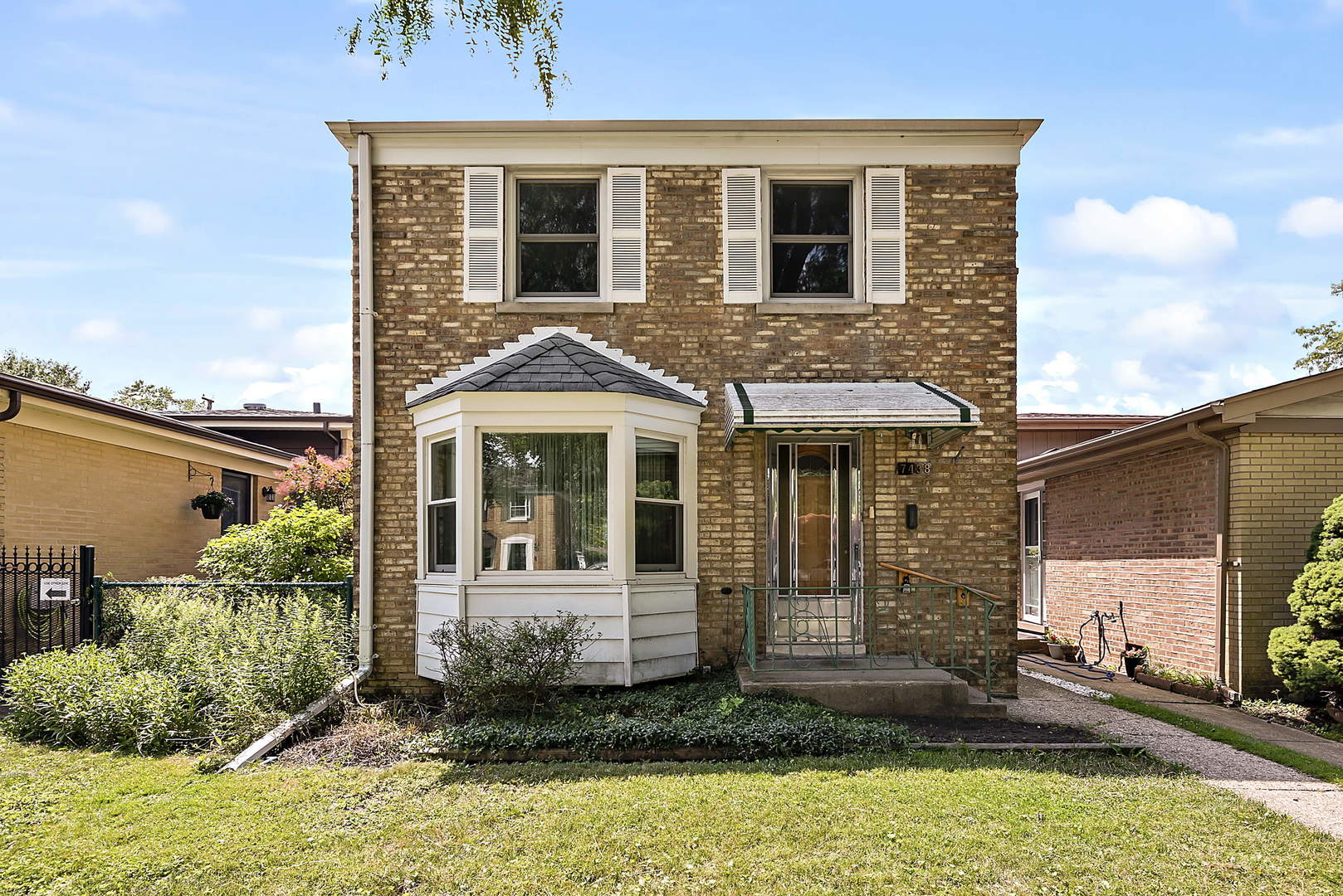 7438 Kenneth Avenue Skokie, IL 60076 - Photo 1 of 17 a front view of a house with garden