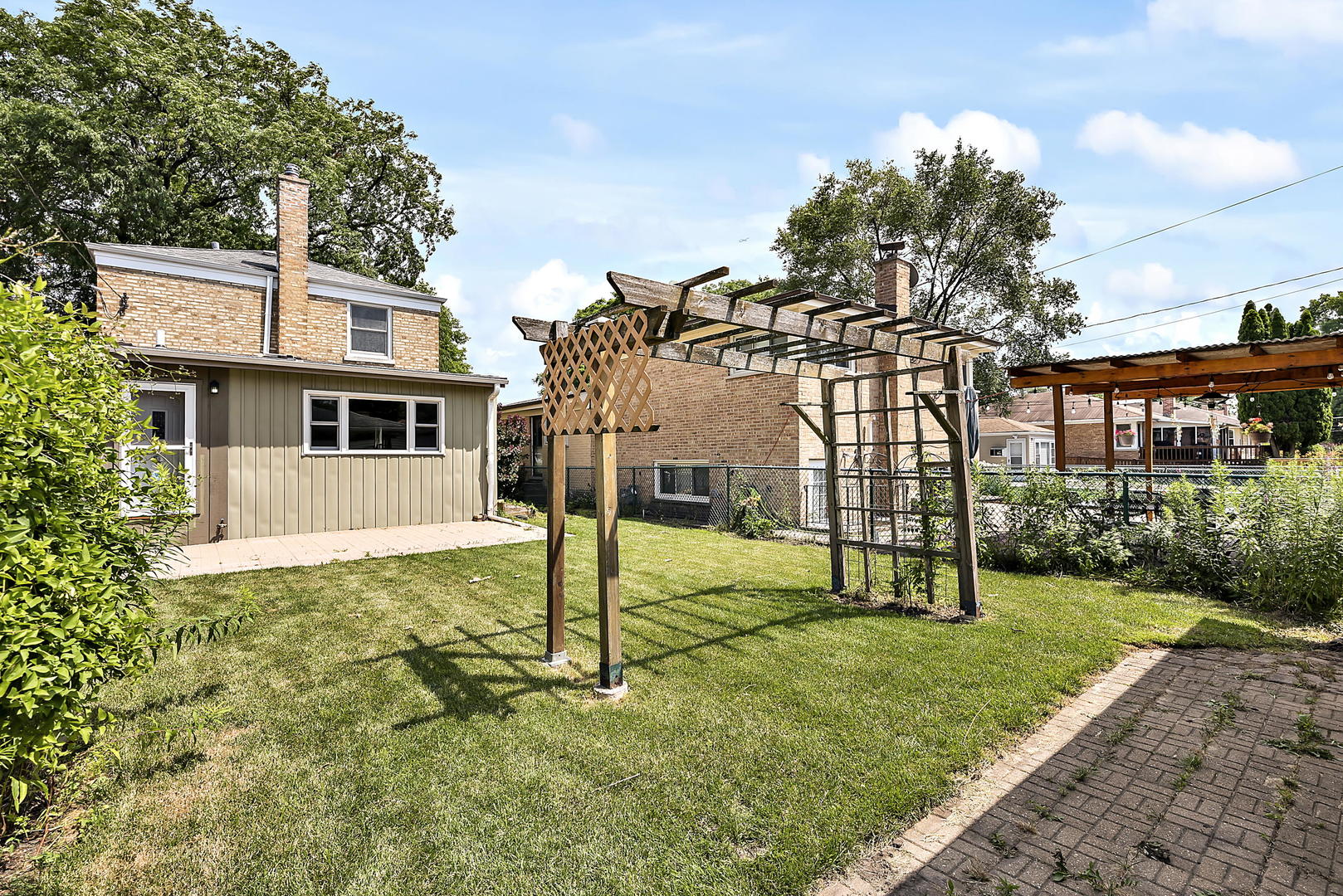 7438 Kenneth Avenue Skokie, IL 60076 - Photo 14 of 17 a view of a house with a backyard