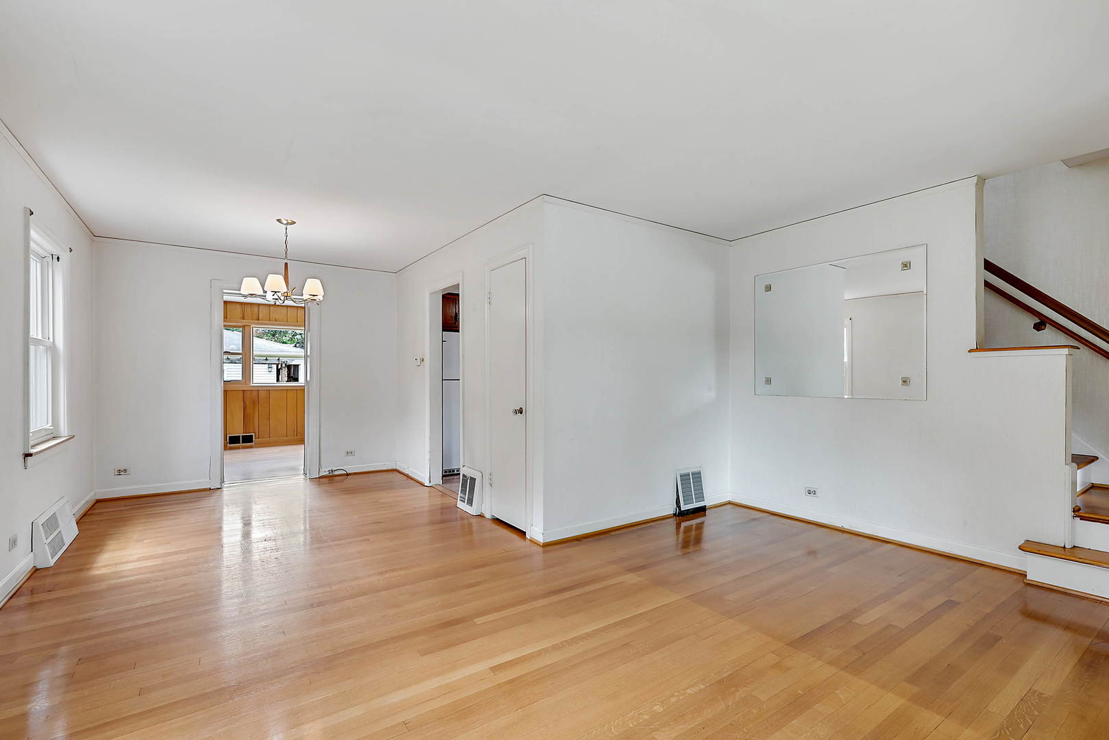 7438 Kenneth Avenue Skokie, IL 60076 - Photo 3 of 17 a view of empty room with wooden floor and window