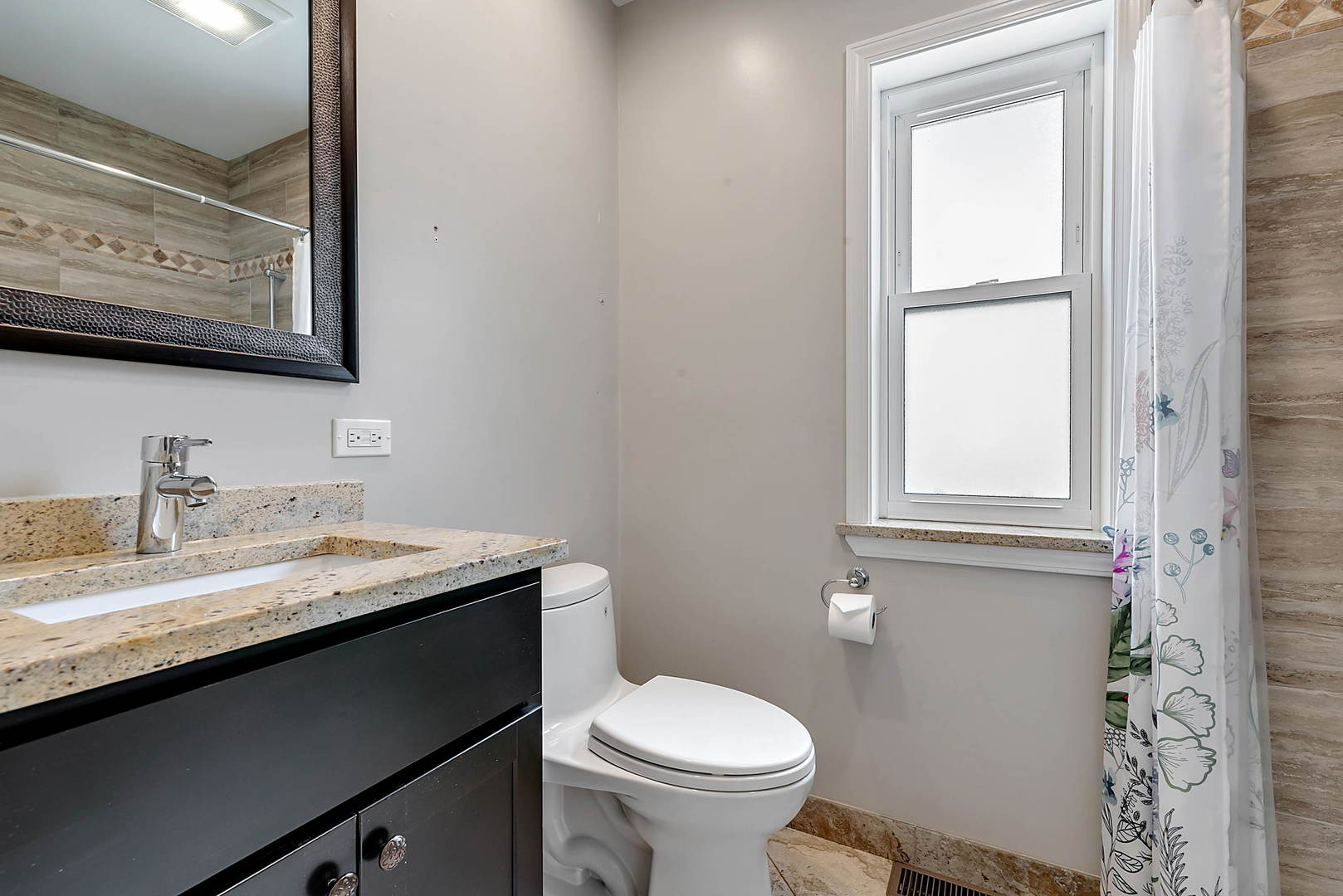 7438 Kenneth Avenue Skokie, IL 60076 - Photo 9 of 17 a bathroom with a granite countertop sink toilet and mirror