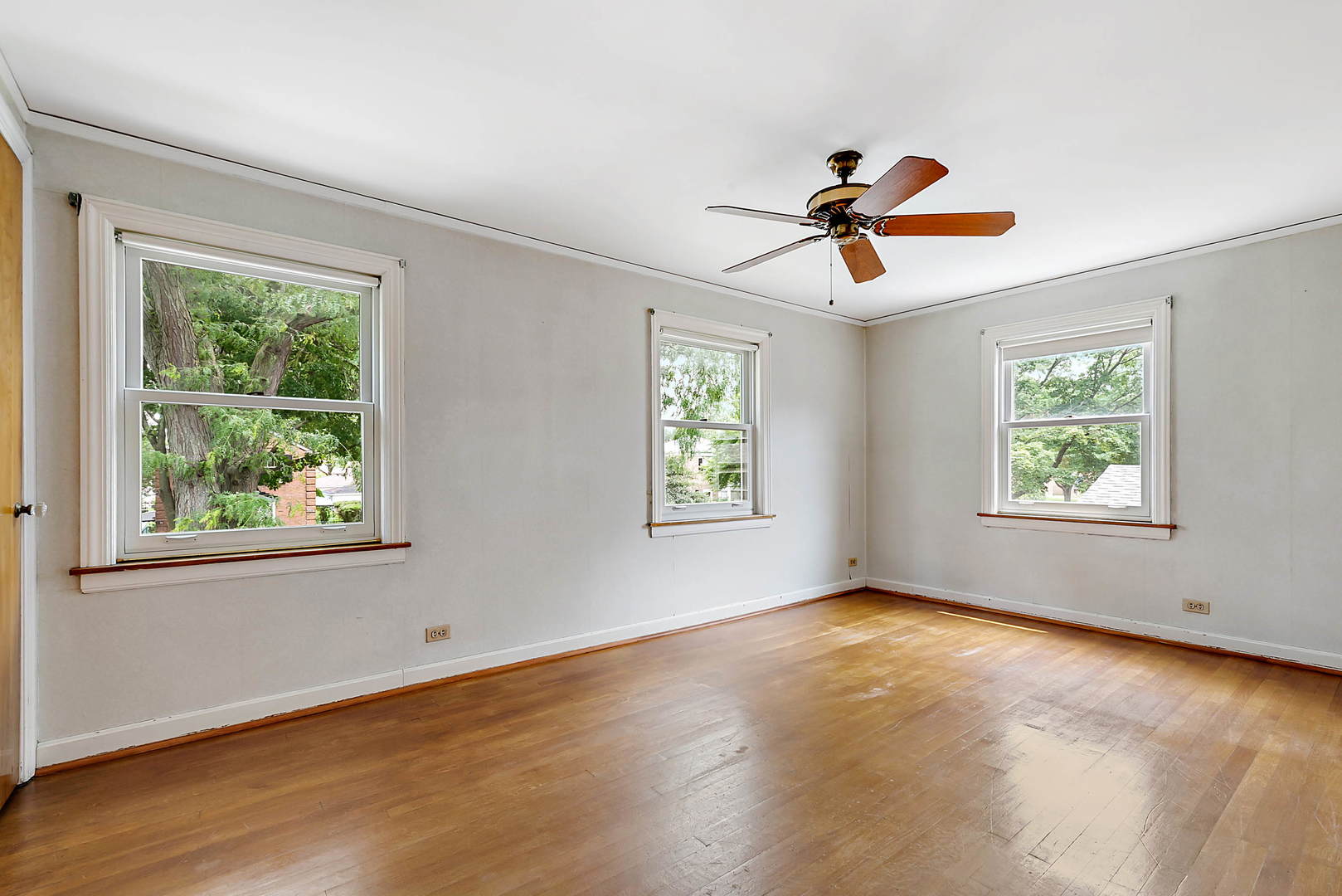 7438 Kenneth Avenue Skokie, IL 60076 - Photo 10 of 17 a view of a room with windows and hardwood floor
