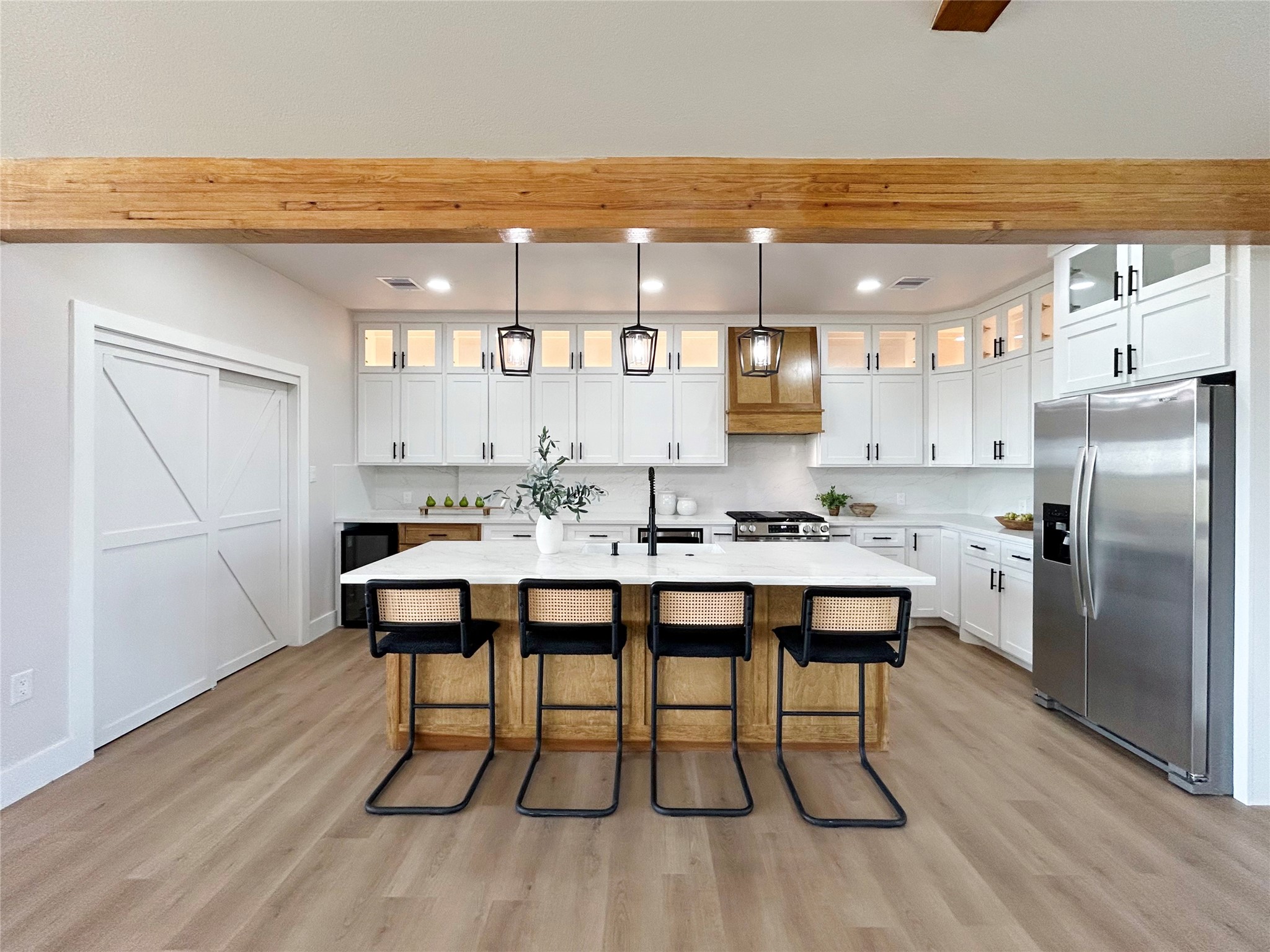 619 Chuckwagon Trail Angleton, TX 77515 - Photo 16 of 35 a kitchen with a dining table chairs and refrigerator
