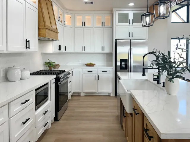 a kitchen with cabinets a sink and appliances