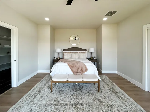 a bedroom with a bed and wooden floor