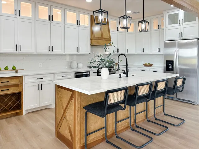 a kitchen with a sink cabinets and appliances