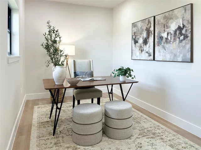 a dining room with furniture and a potted plant