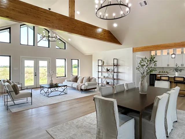 a view of a dining room with furniture and chandelier