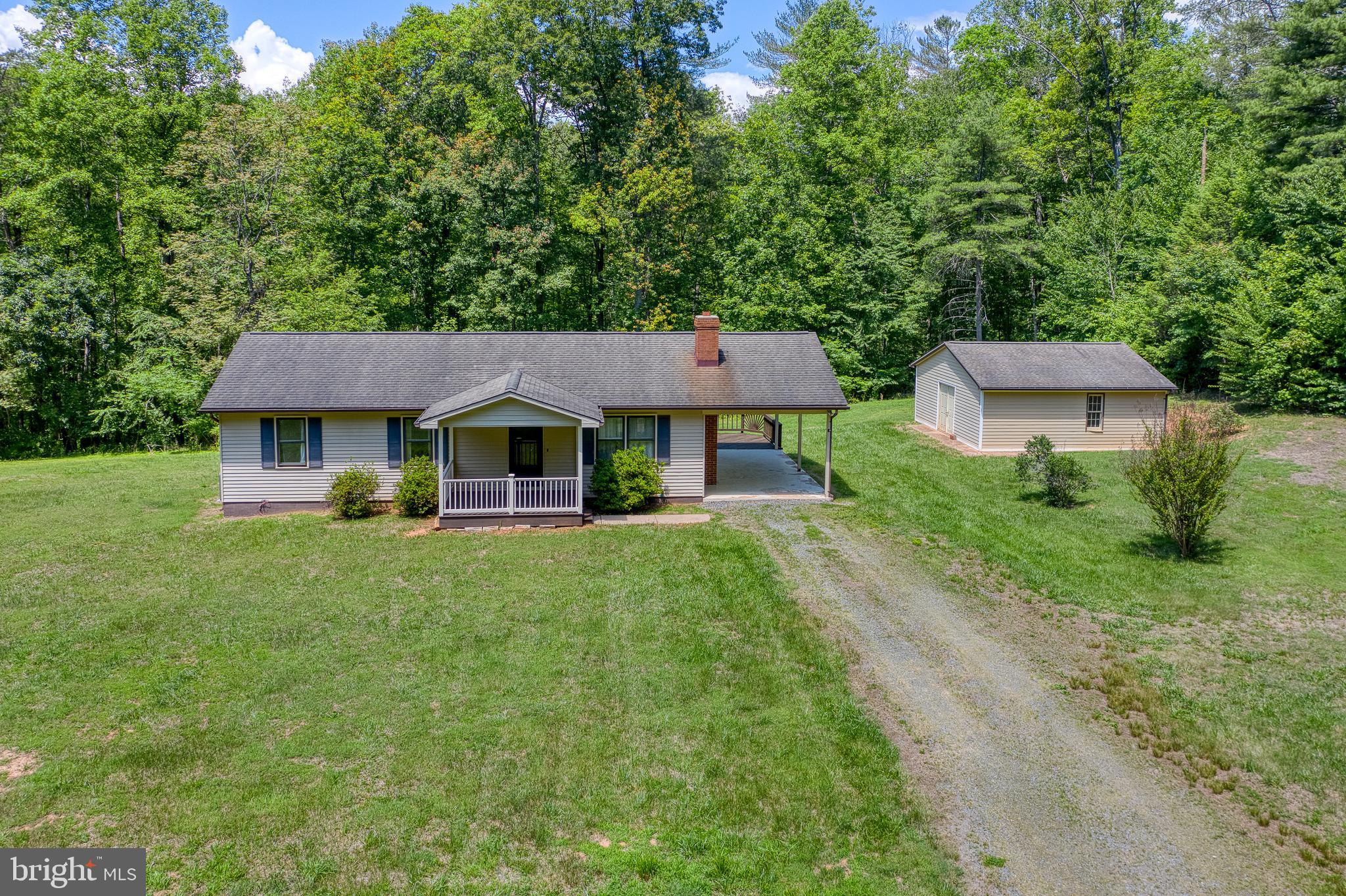 803 Weaver Hollow Road Banco, VA 22711 - Photo 40 of 67 a front view of a house with a yard table and chairs