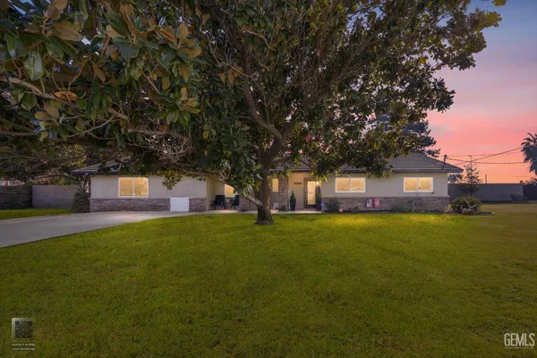 a house with a yard and a large parking space