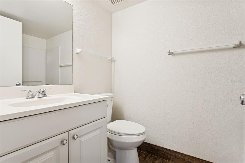 2690 Coral Landings Boulevard, Unit 622 Palm Harbor, FL 34684 - Photo 12 of 31 a bathroom with a toilet a sink and mirror