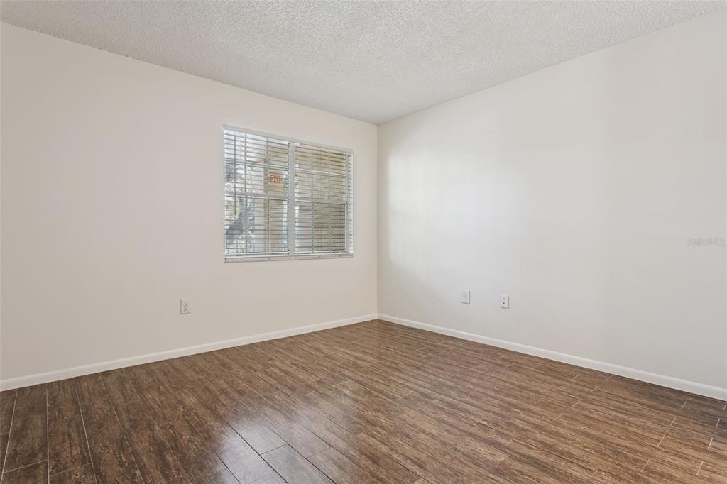 2690 Coral Landings Boulevard, Unit 622 Palm Harbor, FL 34684 - Photo 14 of 31 wooden floor in an empty room with a window