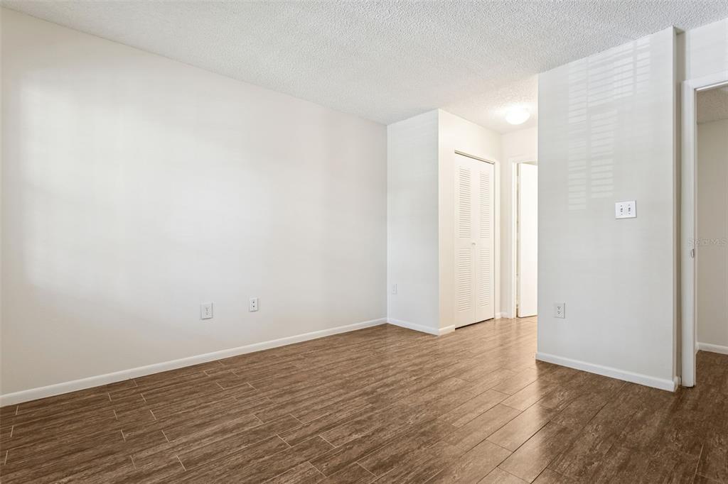 2690 Coral Landings Boulevard, Unit 622 Palm Harbor, FL 34684 - Photo 15 of 31 a view of an empty room with wooden floor and a window