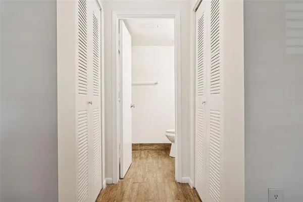 a bathroom with a granite countertop sink toilet and a mirror