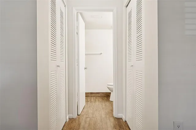 a bathroom with a granite countertop sink toilet and a mirror