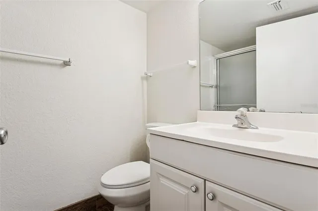 a bathroom with a glass shower door