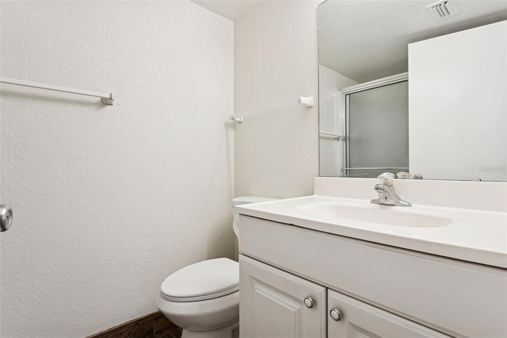 2690 Coral Landings Boulevard, Unit 622 Palm Harbor, FL 34684 - Photo 17 of 31 a bathroom with a granite countertop sink toilet and a mirror
