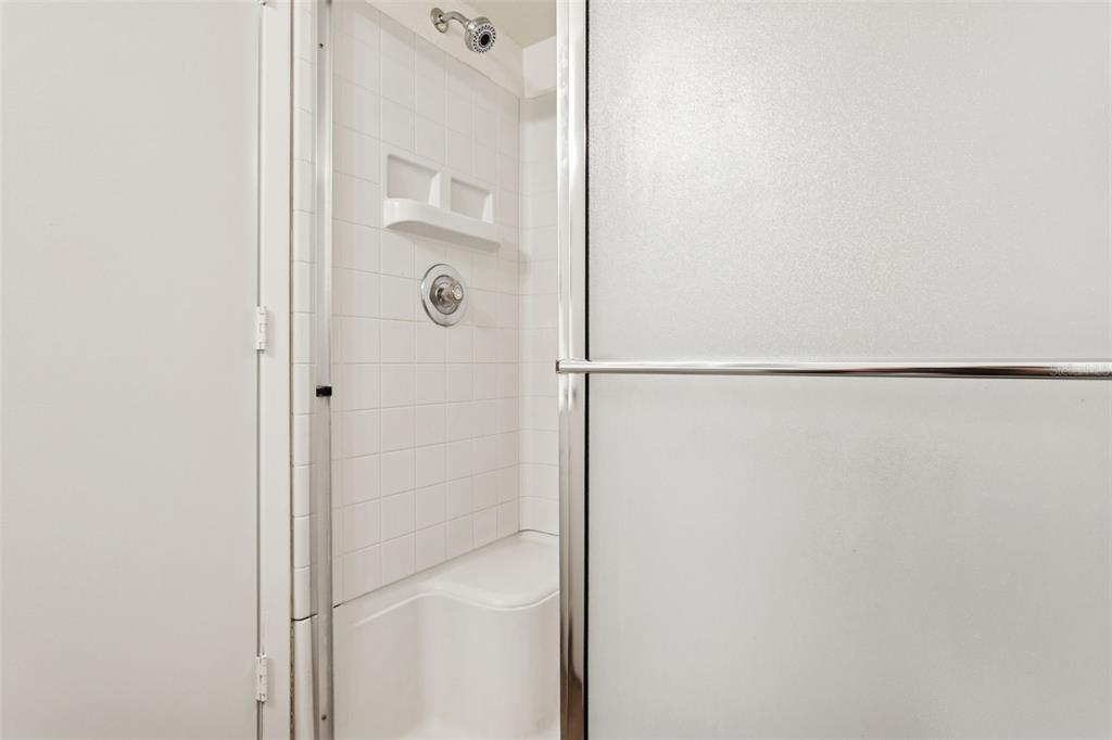 2690 Coral Landings Boulevard, Unit 622 Palm Harbor, FL 34684 - Photo 18 of 31 a bathroom with a glass shower door