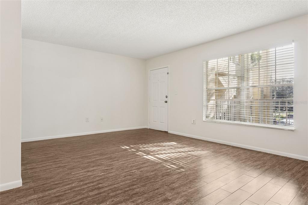 2690 Coral Landings Boulevard, Unit 622 Palm Harbor, FL 34684 - Photo 2 of 31 a view of an empty room with wooden floor and a window