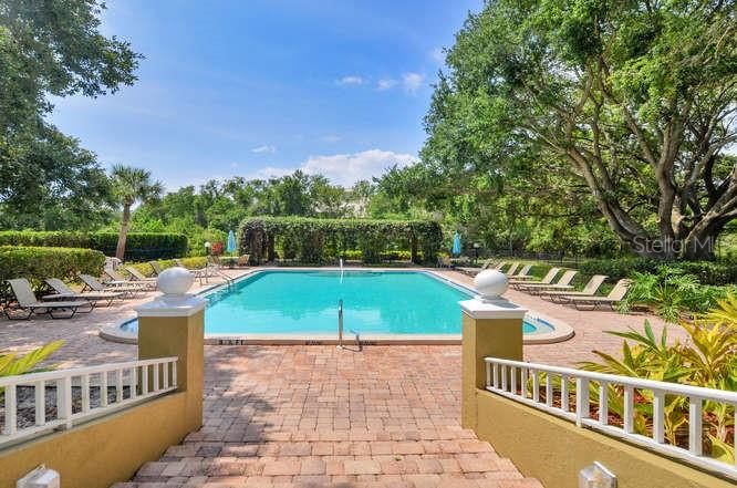 2690 Coral Landings Boulevard, Unit 622 Palm Harbor, FL 34684 - Photo 21 of 31 a view of a swimming pool with a patio and yard