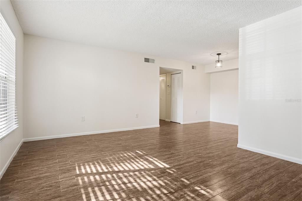 2690 Coral Landings Boulevard, Unit 622 Palm Harbor, FL 34684 - Photo 3 of 31 a view of an empty room with wooden floor and a window