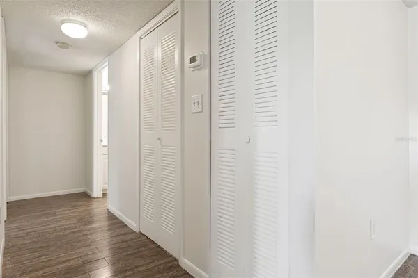 a view of a hallway with wooden floor