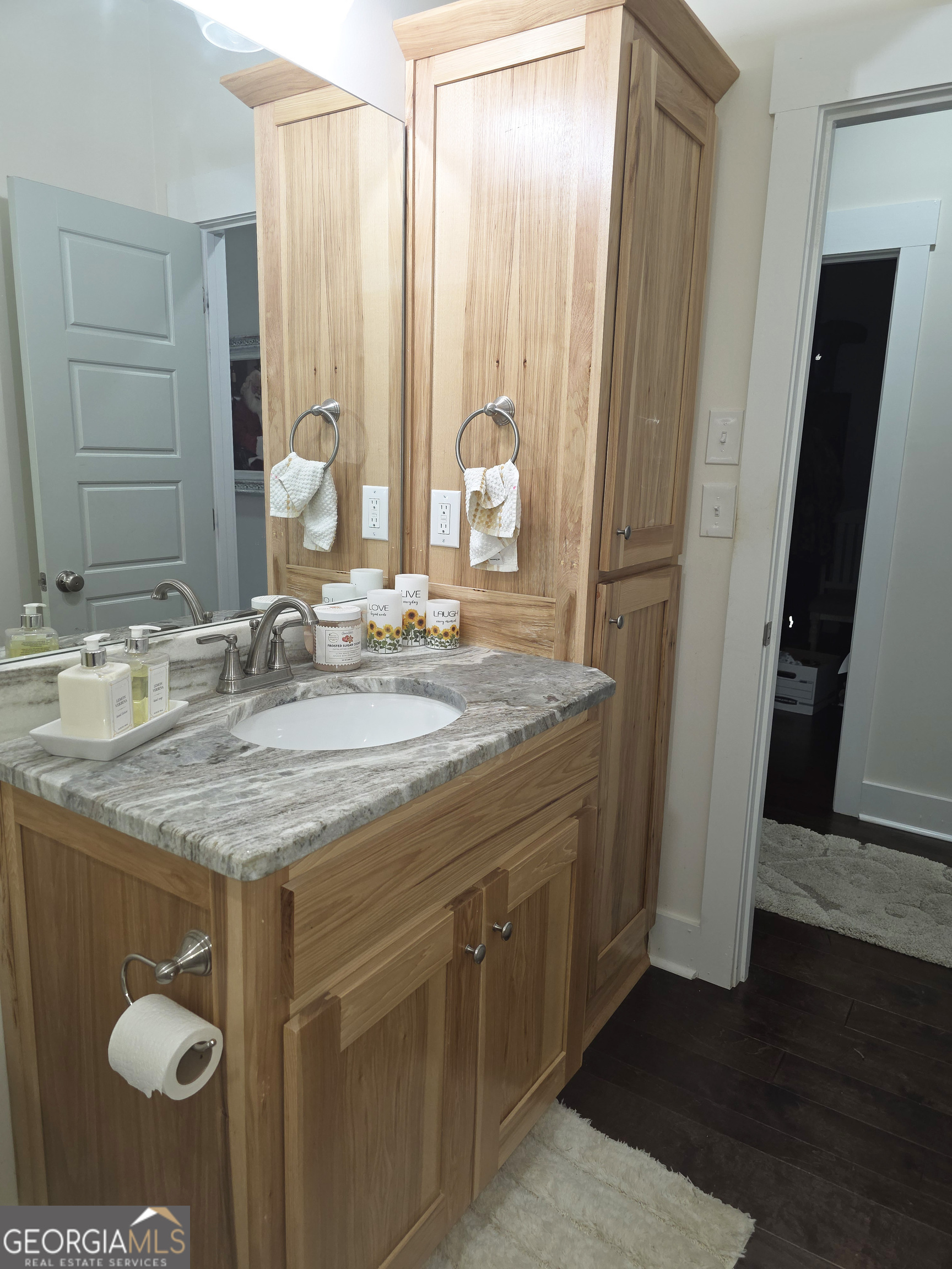 3060 Eatonton Road Madison, GA 30650 - Photo 40 of 65 a bathroom with a granite countertop sink a mirror and a shower