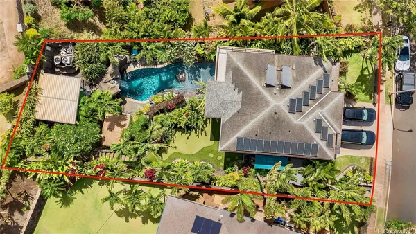 an aerial view of a house with a yard and garden