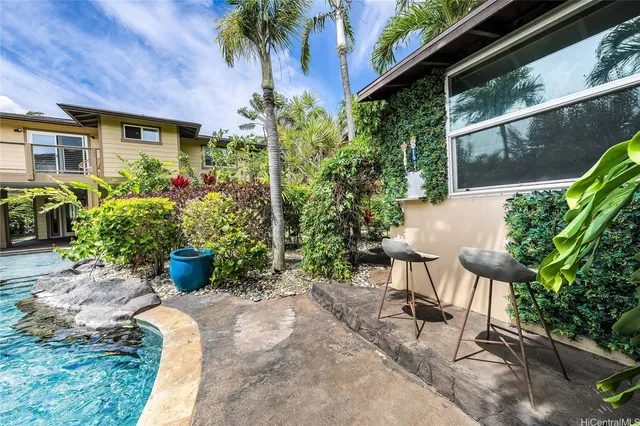 a view of a patio with table and chairs and potted plants